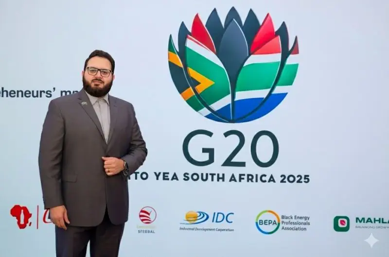 Ahmed Alshareef standing in front of the G20 Young Entrepreneurs' Alliance Summit backdrop