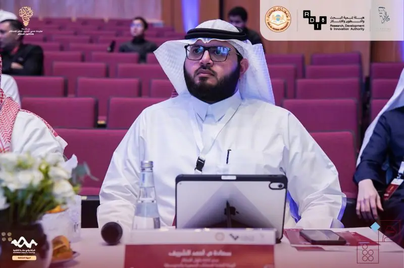 Ahmed Alshareef seated at the judging table with a tablet